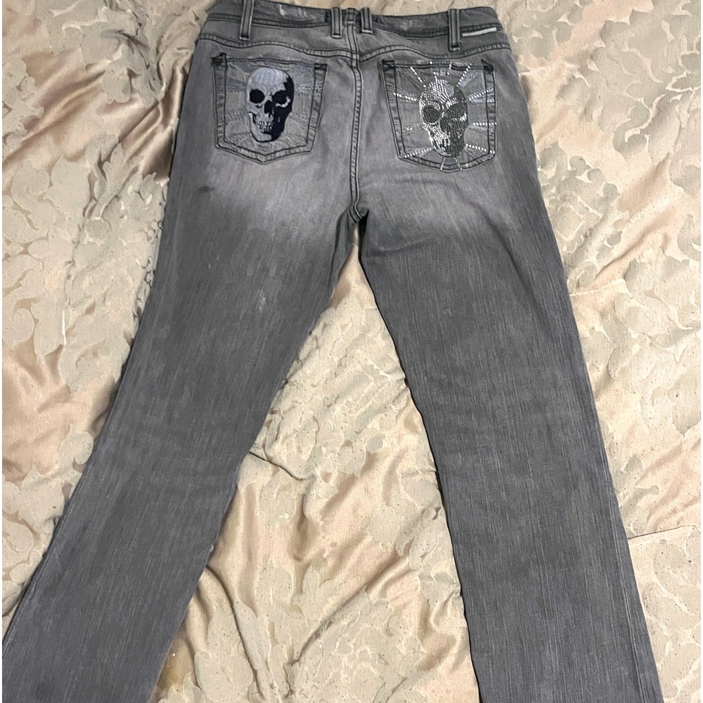 Grey Denim with two different skull designs on the back.